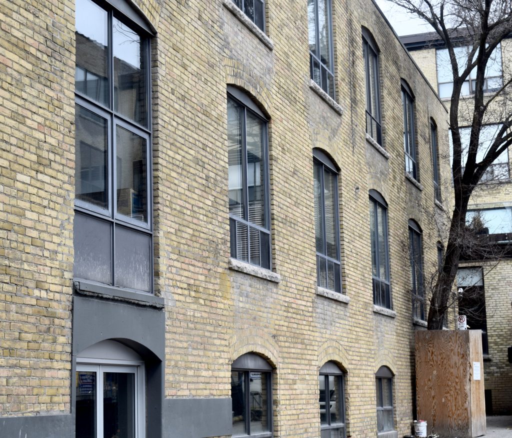 The outside of 107 Atlantic, a brick building. This building used to be apart of the porn industry in Liberty Village.