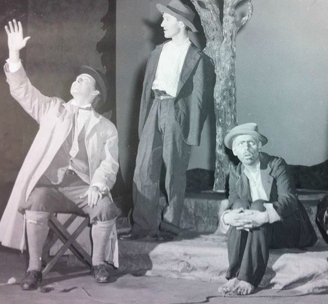 A black and white photo of three performers onstage acting Samuel Beckett's "Waiting for Godot".