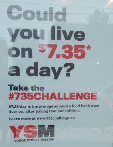 The storefront of Double Take thrift shop displaying the phrase "Could you live on $7.35 a day?" boldly in the front window.on Wednesday Feb. 6, 2019. Kyle Craib/RSJ