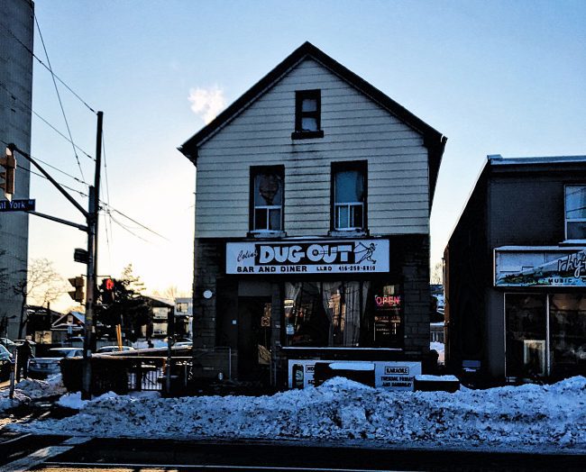 A freestanding building with Colin's Dug Out printed in white lettering on a sign.