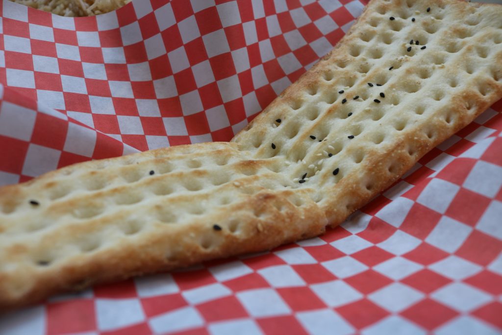 Naan bread sitting in a basket.