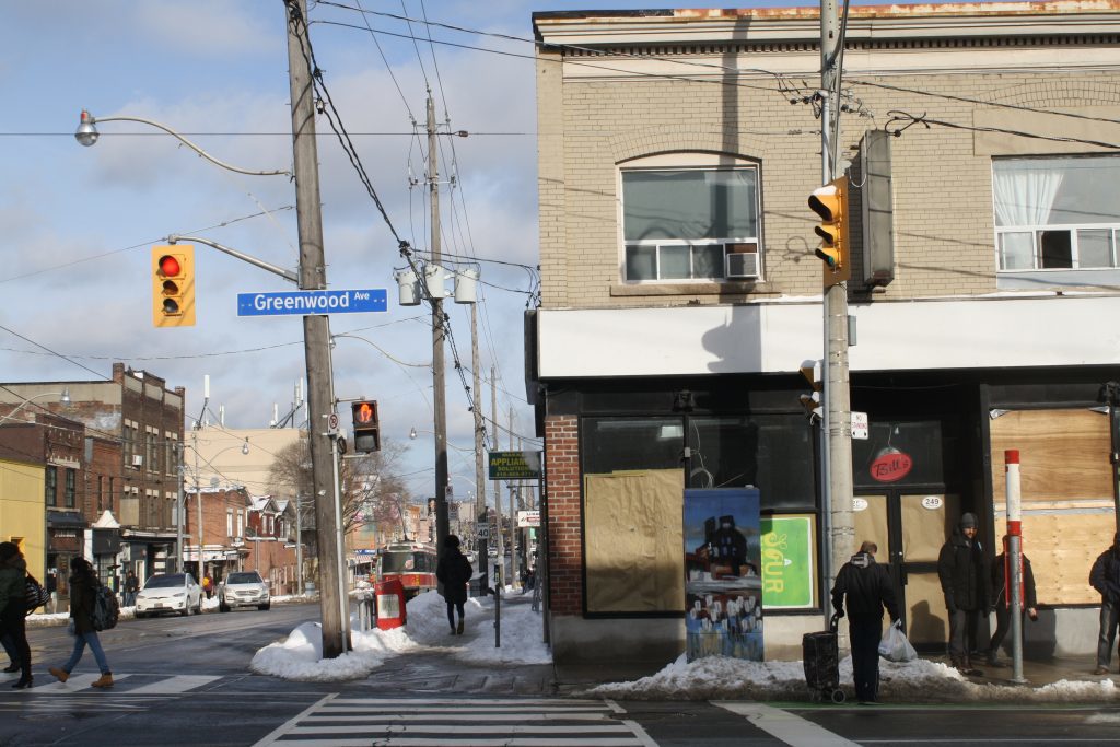 Corner of the street with light post and street sign that says "Greenwood Ave."