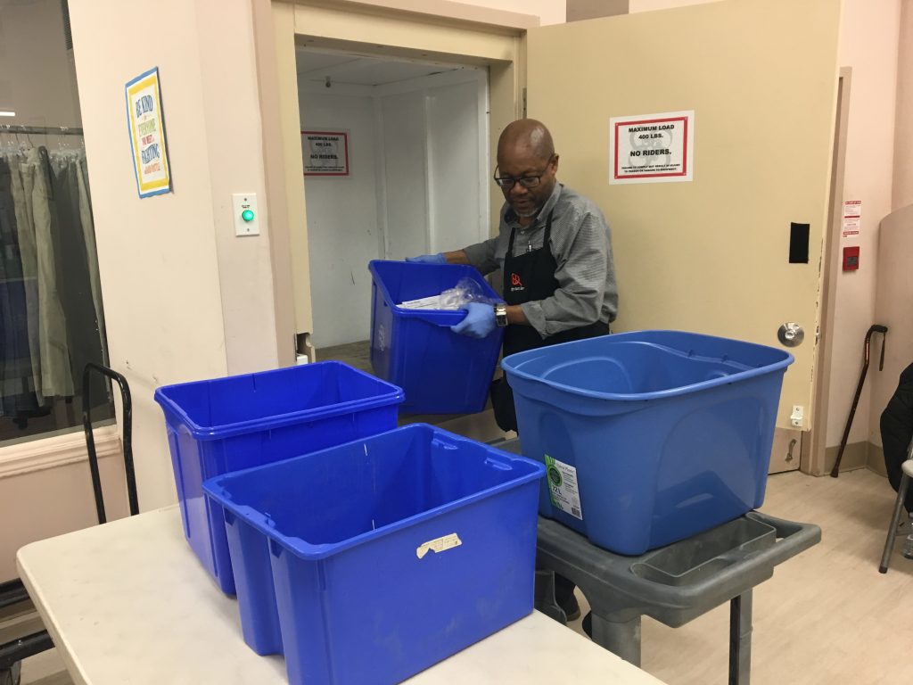 Bins being moved from the dumbwaiter. 