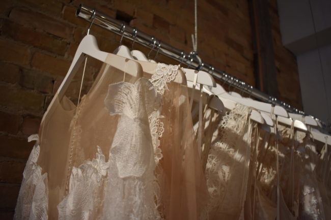 Rows of different style wedding dresses.