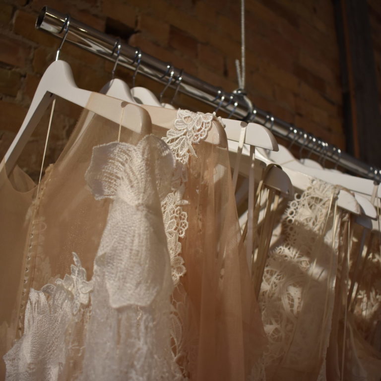 Rows of different style wedding dresses.