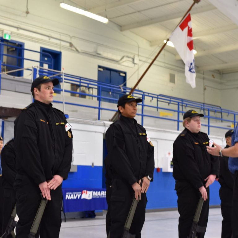 5 Group of people in uniform doing rifle drill while their instructor is teaching.