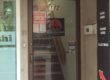 a street image of the store entrance to three kingdoms games. There is a staircase behind the door that leads up to the store itself.