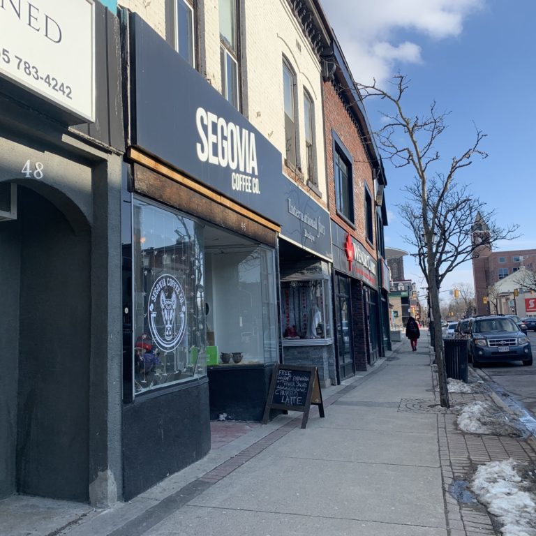 Sidewalk leading up to the storefront of Segovia coffee co.