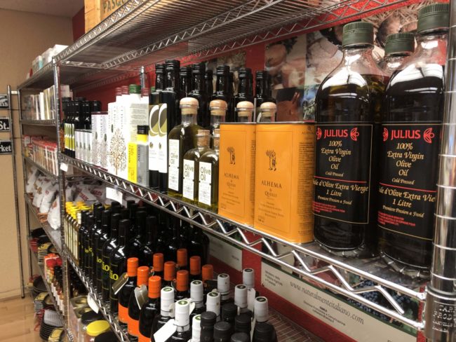 Oils and vinaigrettes on a metal shelf.