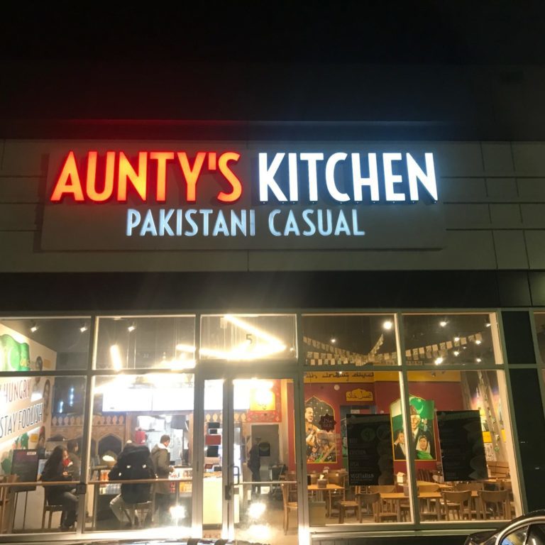 The storefront of Aunty's Kitchen. There are large windows that look into the interior of the store.