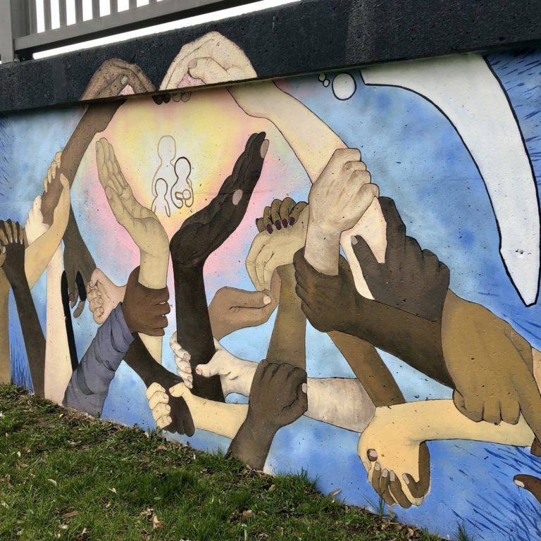 IMG_9401 Mural of hands of different colors coming together and forming a heart.