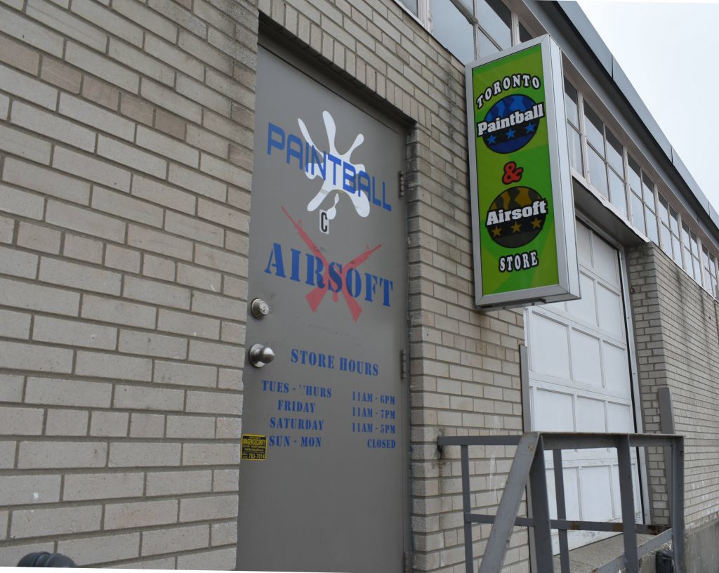 A door with "Paintball (&) Airsoft", next to a sign saying 'Toronto Paintball & Airsoft Store.'