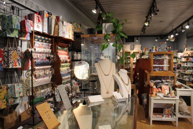 Store shelves that feature jewellery, gift bags, and wrapping paper.