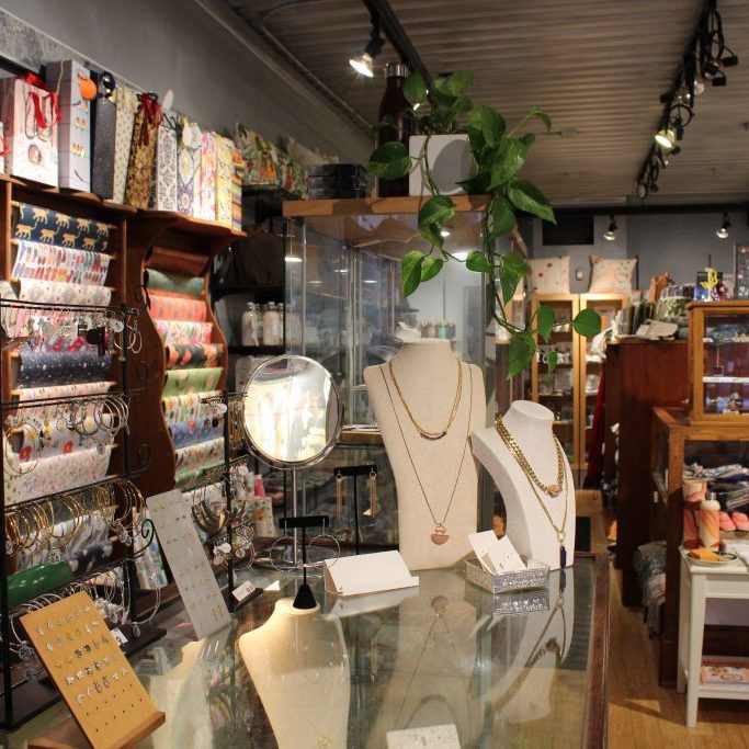 Store shelves that feature jewellery, gift bags, and wrapping paper.
