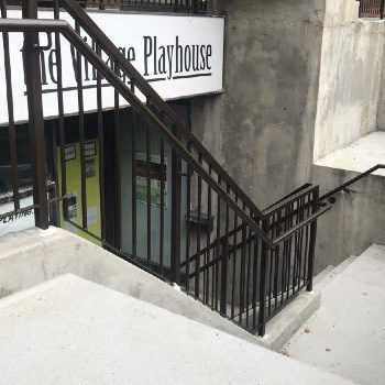 Concrete stairs leading down to the village playhouse theatre.