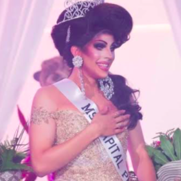 Adrianna Exposée in a champagne colored dress and a tiara.