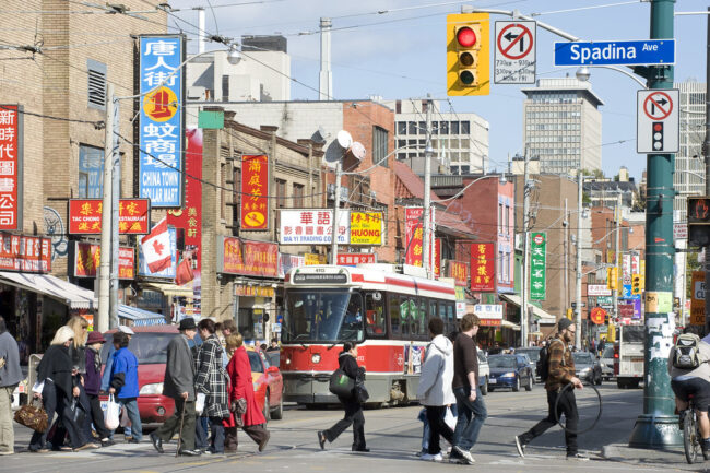 Pedestrians crossing a street in Chinatown.