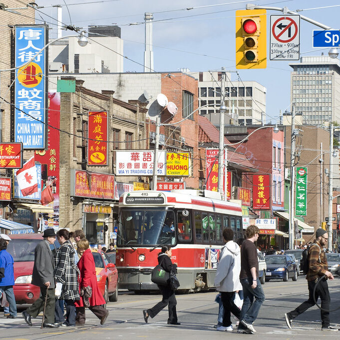 Pedestrians crossing a street in Chinatown.