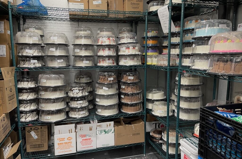 Cakes lined up on shelves in a walk-in freezer at Dairy Queen.
