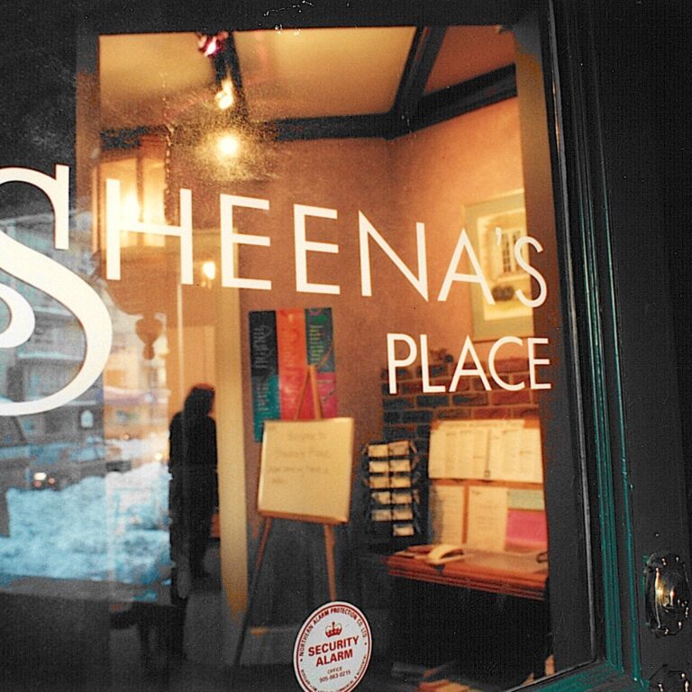 Logo of "Sheena's Place" on a window.
