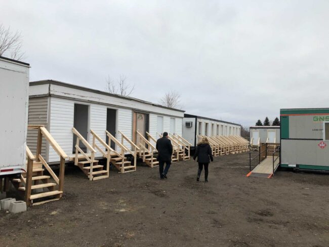 Lot with many mobile homes with wooden stairs.