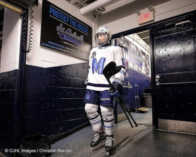 Man in a white hockey uniform.
