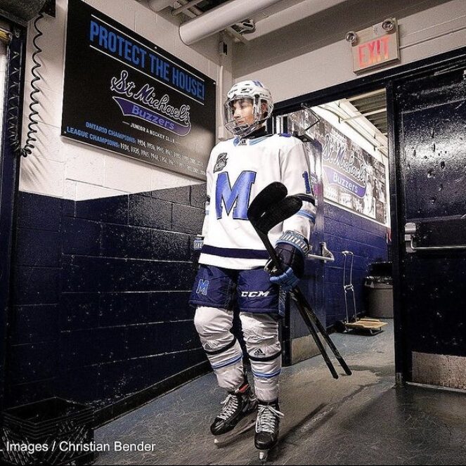 Man in a white hockey uniform.