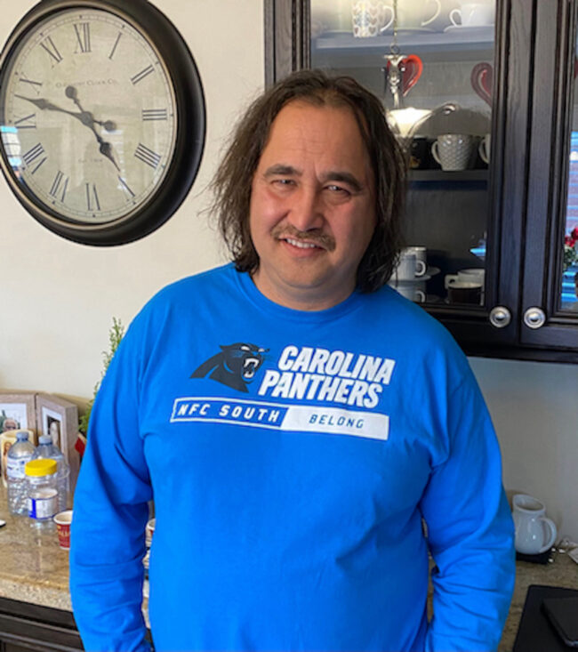 Man in a royal blue sweater.