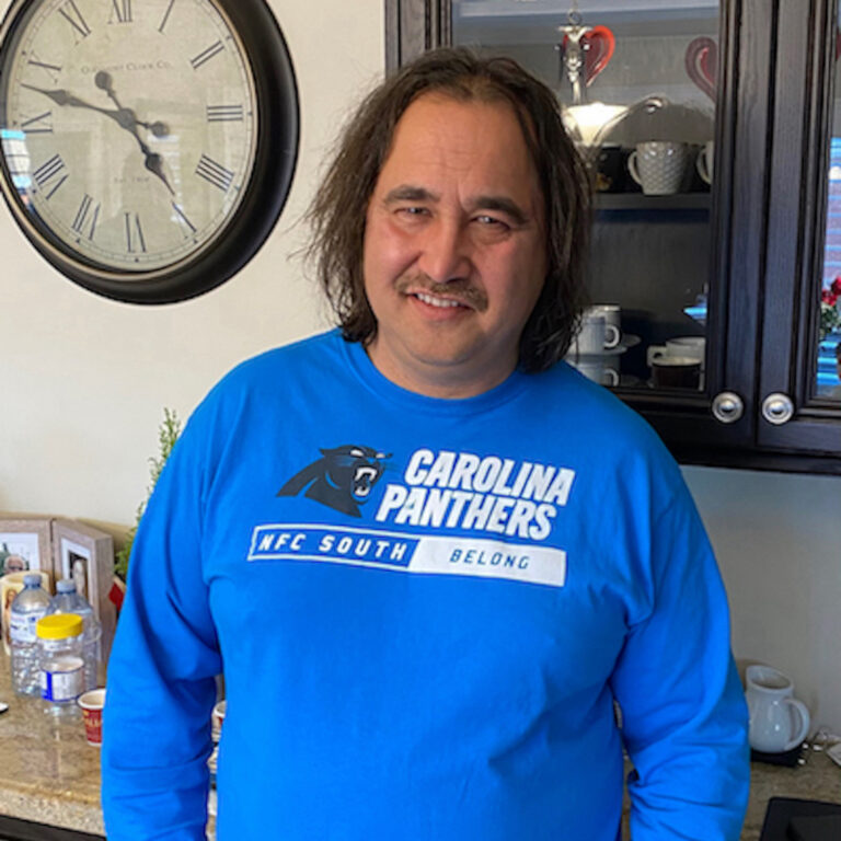 Man in a royal blue sweater.