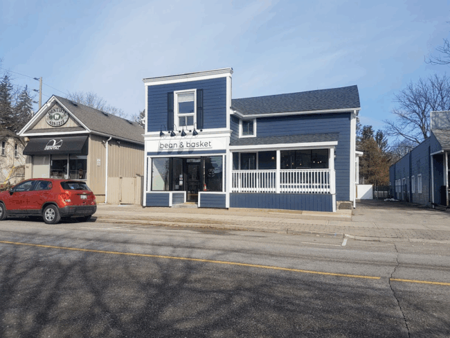 Storefront of the blue building of Bean and Basket.