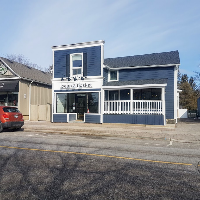 Storefront of the blue building of Bean and Basket.