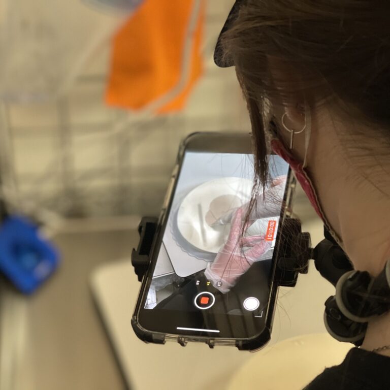Girl filming herself decorating a cake