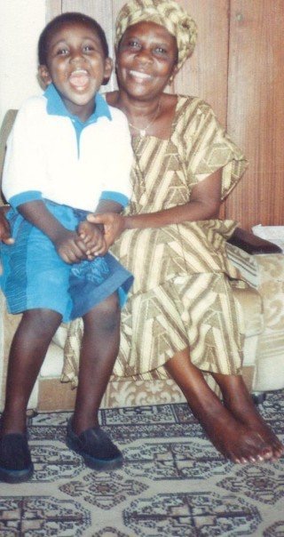 A  young boy sitting next to an older woman.