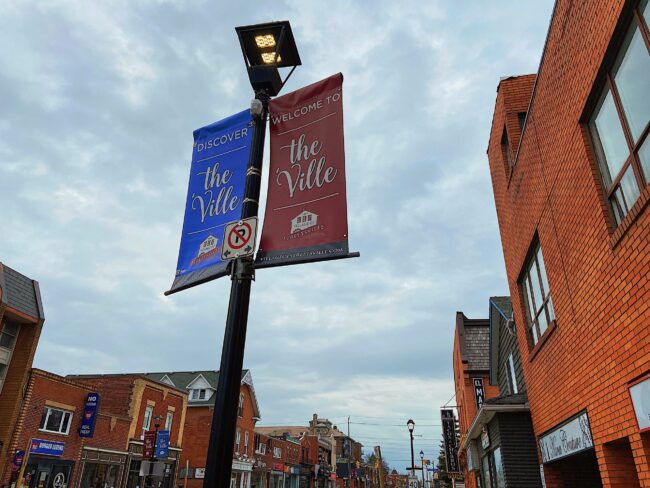 Street lamp with two different colored signs.