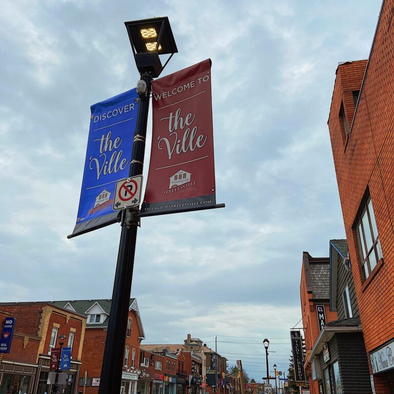 IMG_7468 Street lamp with two different colored signs.