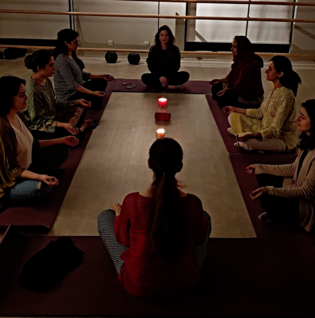 Sheikh meditating with a group of people. This is one of the new business ventures she has decided to taken and is more explained in the story.