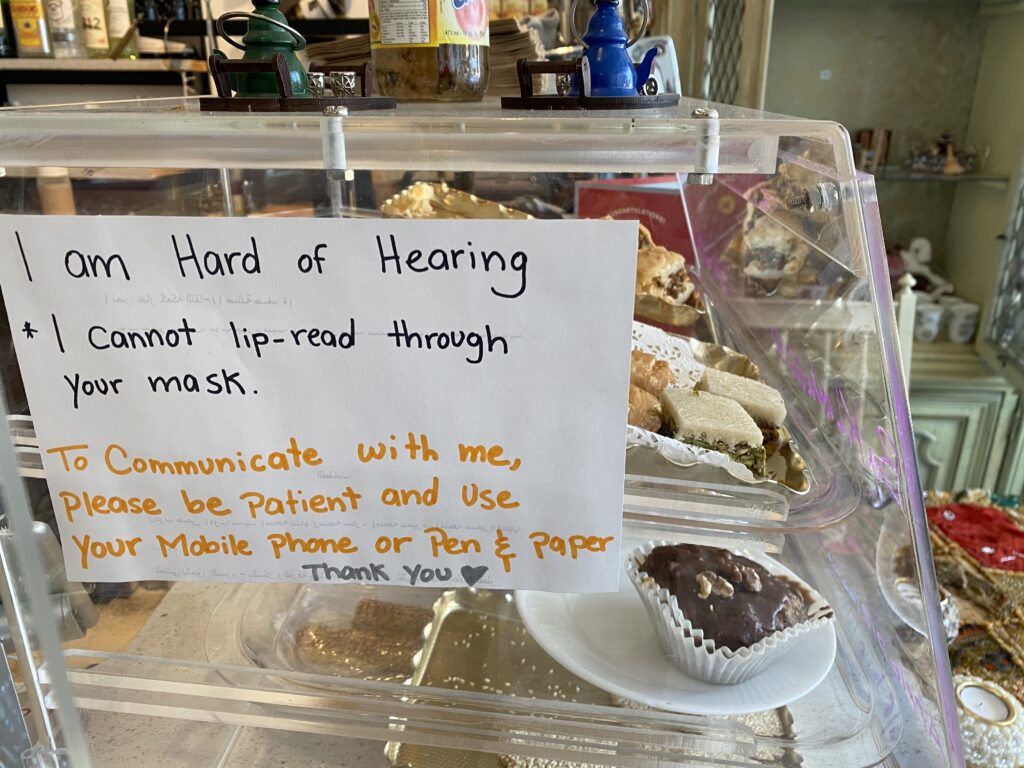 A note which says, "I am hard of hearing. I cannot lip-read through your mask. To communicate with me, please be patient and use your mobile phone or pen and paper." With a "thank you" and a heart drawing at the end.