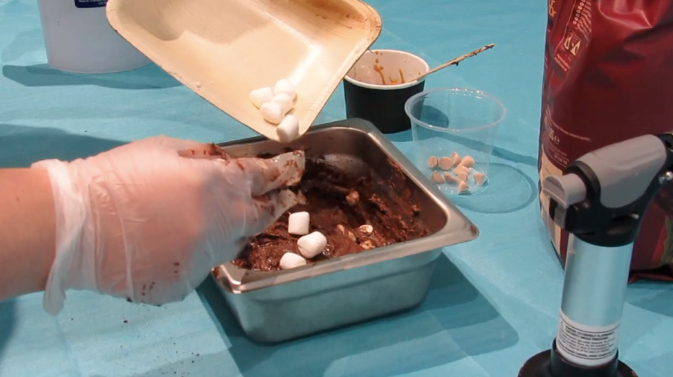 Rujuta Agate drops a cluster of marshmallows into the salted caramel hot cocoa cookie dough mix at Pandoughra’s Box.
