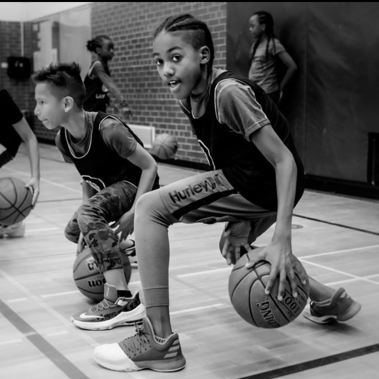 Lay-Up Youth Basketball Boy dribbling a basketball in a school gym
