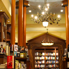 The inside of a bookstore. Display pile of books on the left.