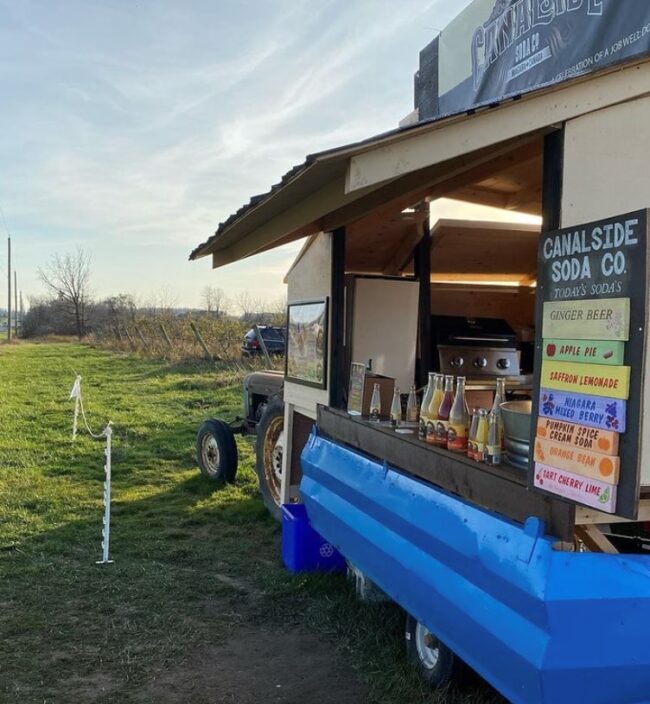 Food truck out in an empty field.