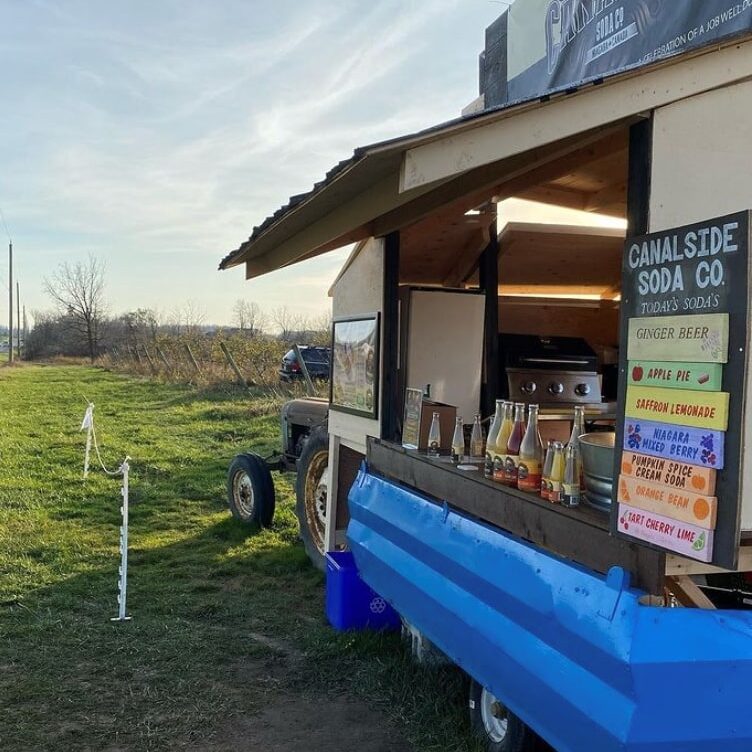 Food truck out in an empty field.