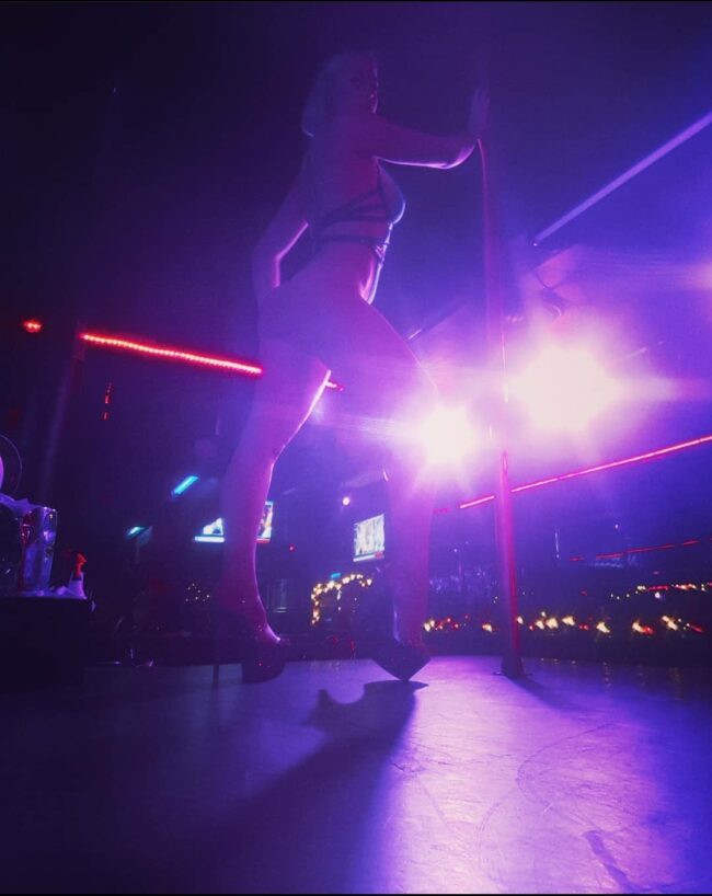 Woman pole dancing.