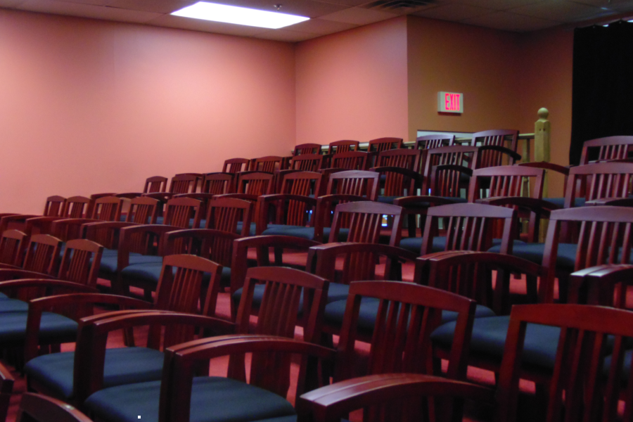 Medium shot of rows of chairs in a concert hall.