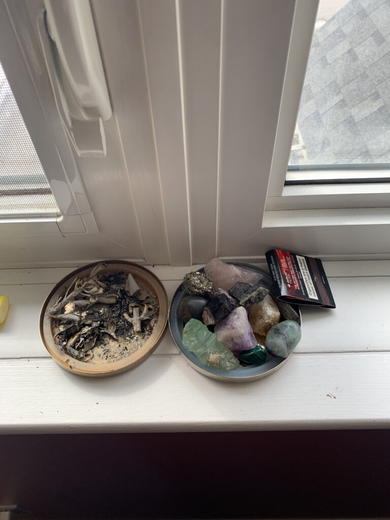 Photo of a collection of crystals and sage ashes.