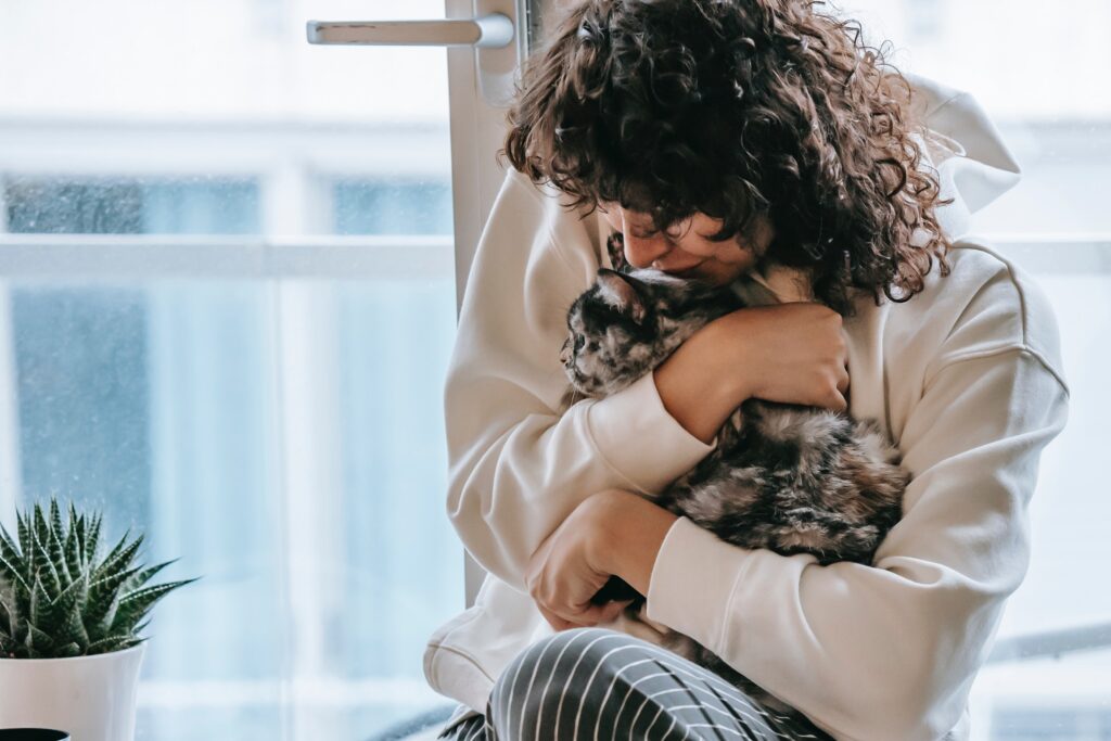 Woman hugging cat