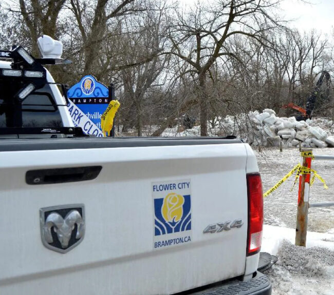 White ram pickup truck with Flower City Brampton logo on the back.
