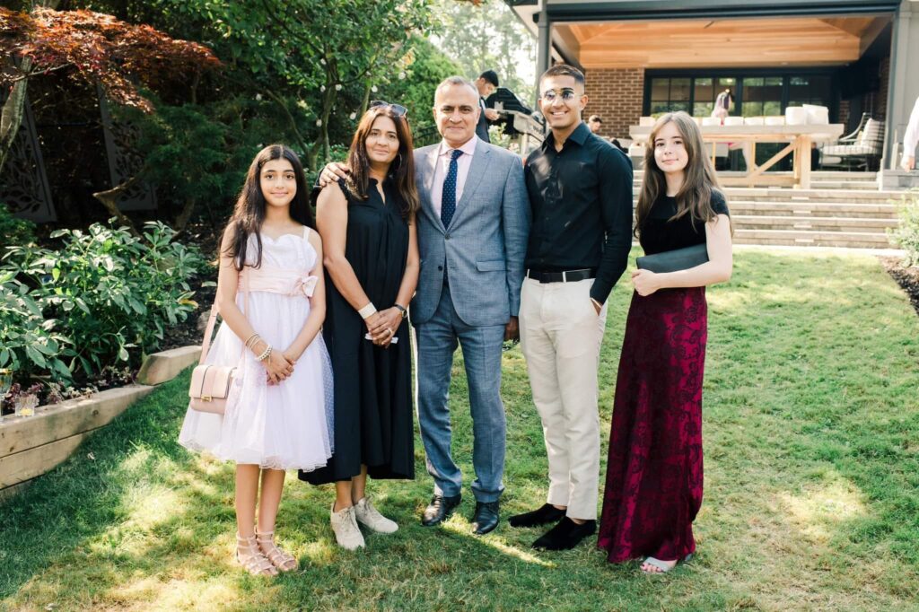 A family poses for a photo side by side