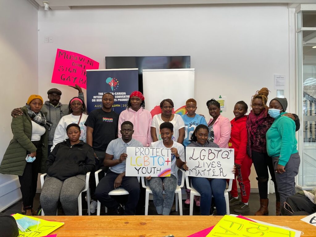 A group from the African Centre for Refygees in Ontario-Canada hold signs they made for a protest.