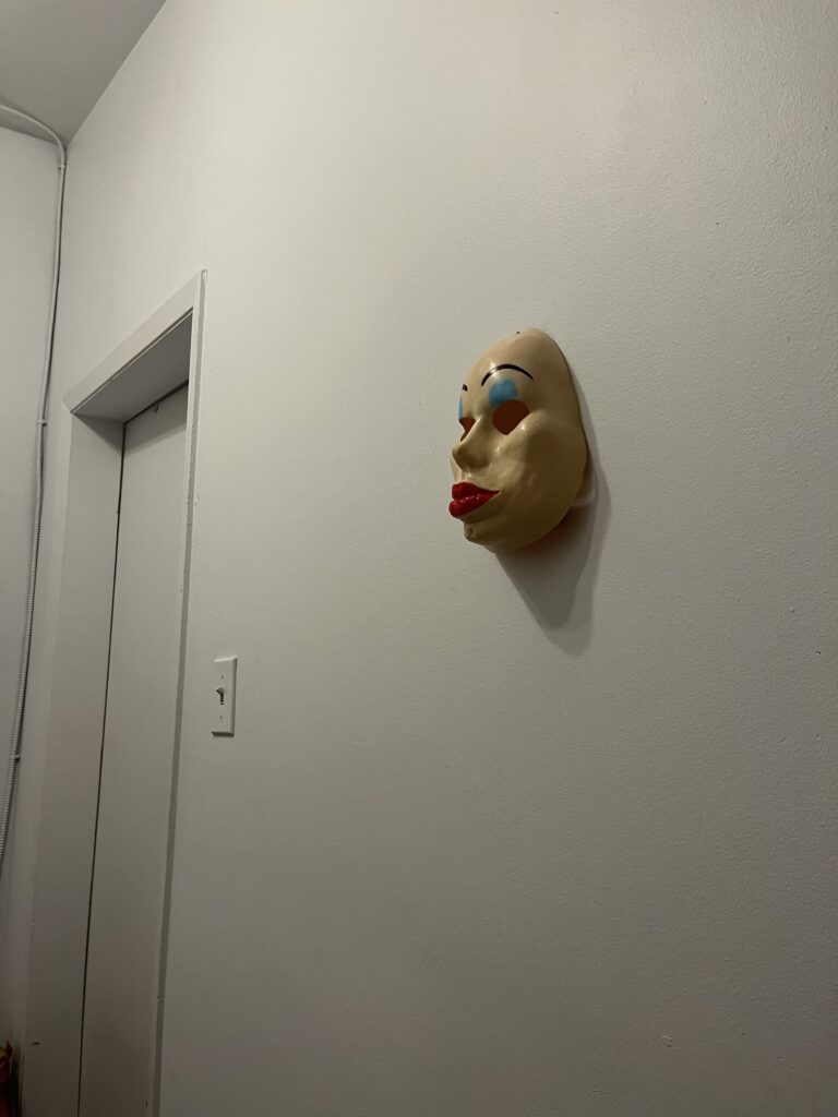 Halloween mask on an empty wall.